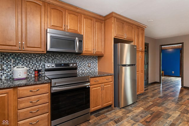 1202 E Stop 10th Rd, Indianapolis, IN 46227 - kitchen with appliances with stainless steel finishes, backsplash, dark stone counters, and dark wood finished floors