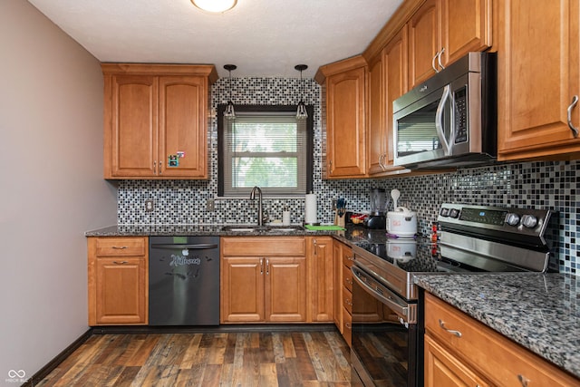 1202 E Stop 10th Rd, Indianapolis, IN 46227 - kitchen featuring stainless steel appliances, dark wood-type flooring, and brown cabinets