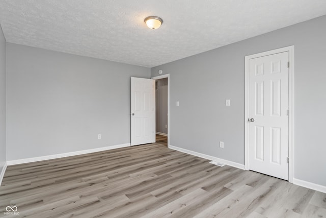 2359 Bremhaven Ct, Indianapolis, IN 46229 - unfurnished bedroom with light wood-style floors and a textured ceiling