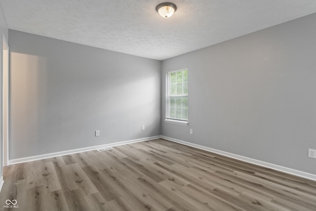 2359 Bremhaven Ct, Indianapolis, IN 46229 - spare room featuring a textured ceiling and wood finished floors