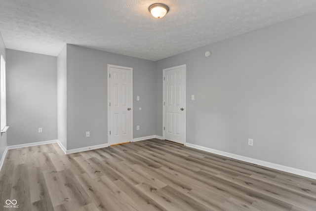 2359 Bremhaven Ct, Indianapolis, IN 46229 - empty room with a textured ceiling and light wood-style floors