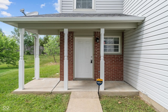 2359 Bremhaven Ct, Indianapolis, IN 46229 - doorway to property featuring brick siding, a lawn, and roof with shingles