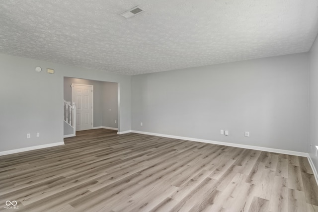 2359 Bremhaven Ct, Indianapolis, IN 46229 - spare room with wood finished floors, a textured ceiling, and stairway