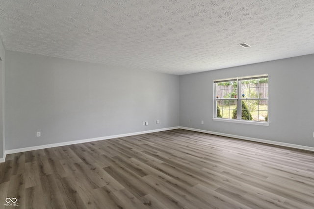 2359 Bremhaven Ct, Indianapolis, IN 46229 - spare room featuring a textured ceiling and wood finished floors