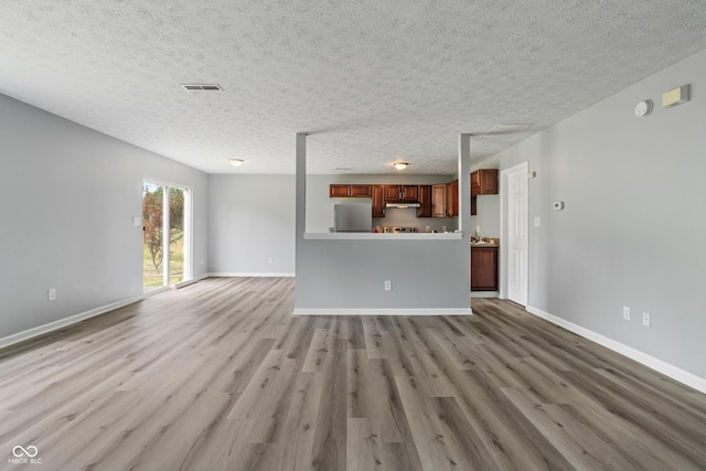 2359 Bremhaven Ct, Indianapolis, IN 46229 - unfurnished living room featuring wood finished floors and a textured ceiling
