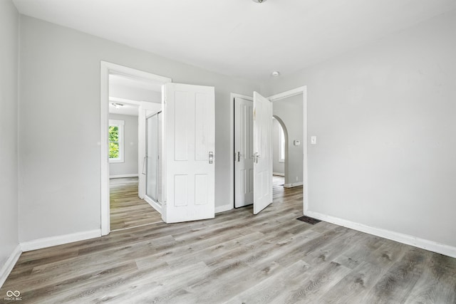 3424 Orchard Ave, Indianapolis, IN 46218 - unfurnished bedroom with wood finished floors and arched walkways