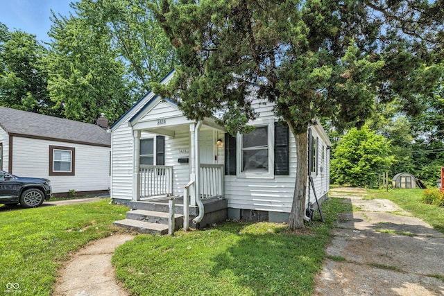 3424 Orchard Ave, Indianapolis, IN 46218 - view of front facade featuring a front lawn and a shed