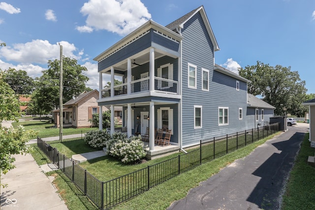 847 E Jefferson St, Franklin, IN 46131 - view of side of property featuring a balcony, a ceiling fan, a fenced front yard, and covered porch