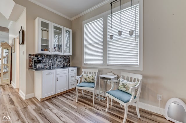 847 E Jefferson St, Franklin, IN 46131 - indoor dry bar with light wood-style flooring, ornamental molding, and decorative backsplash