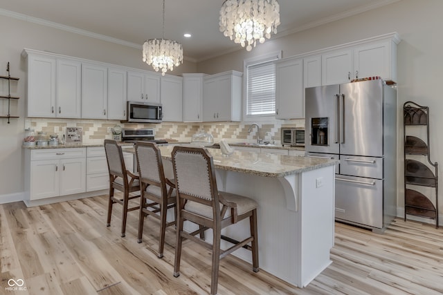 847 E Jefferson St, Franklin, IN 46131 - kitchen featuring stainless steel appliances, a chandelier, white cabinetry, light wood finished floors, and ornamental molding