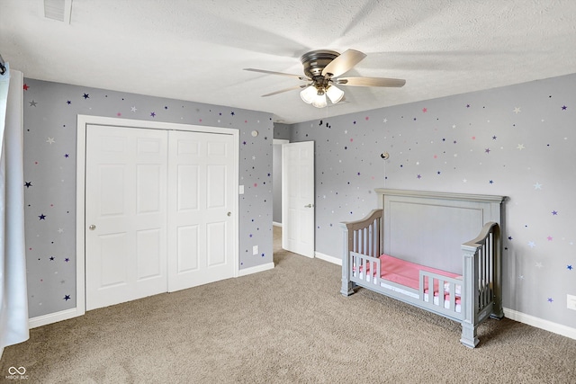 421 Lowry St, Jamestown, IN 46147 - carpeted bedroom with a closet, a ceiling fan, a textured ceiling, and a nursery area