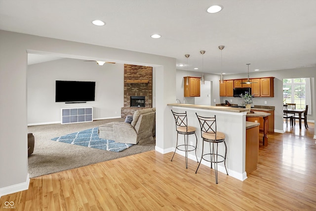 421 Lowry St, Jamestown, IN 46147 - kitchen featuring black microwave, a breakfast bar area, open floor plan, a peninsula, and recessed lighting