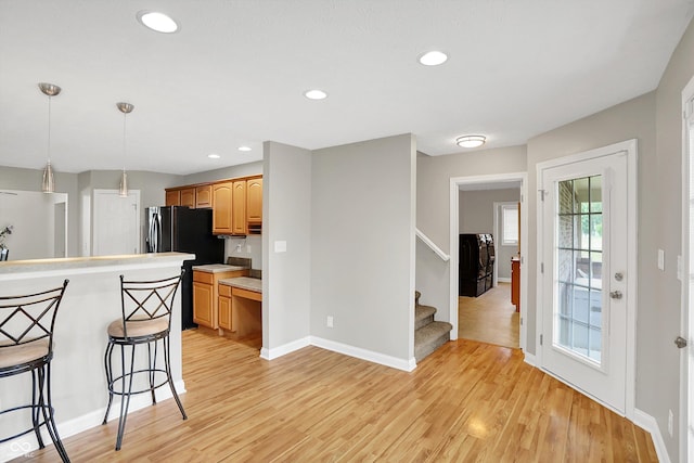 421 Lowry St, Jamestown, IN 46147 - kitchen featuring light countertops, light wood-style flooring, a kitchen bar, decorative light fixtures, and recessed lighting