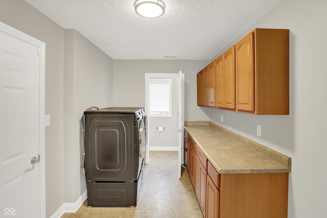 421 Lowry St, Jamestown, IN 46147 - laundry area with washer and clothes dryer, cabinet space, and a textured ceiling