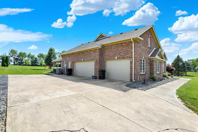 421 Lowry St, Jamestown, IN 46147 - view of home's exterior with driveway, brick siding, a lawn, a shingled roof, and a garage