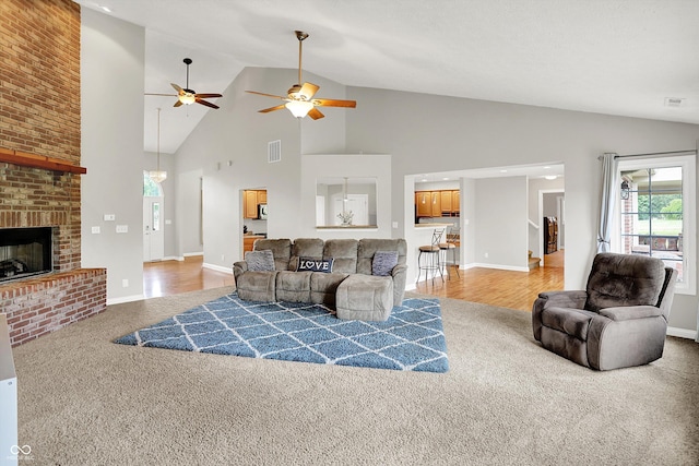 421 Lowry St, Jamestown, IN 46147 - living room with carpet, high vaulted ceiling, ceiling fan, and a brick fireplace