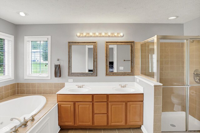 421 Lowry St, Jamestown, IN 46147 - bathroom with a shower stall, a bath, double vanity, and a textured ceiling