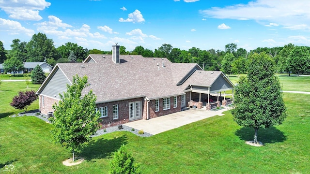 421 Lowry St, Jamestown, IN 46147 - back of property featuring a patio area, brick siding, a lawn, and roof with shingles