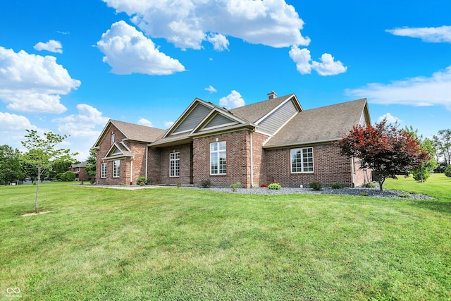 421 Lowry St, Jamestown, IN 46147 - view of front facade with brick siding, a front yard, and a shingled roof