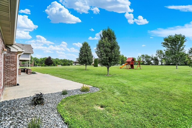 421 Lowry St, Jamestown, IN 46147 - view of grassy yard with a patio area and a playground