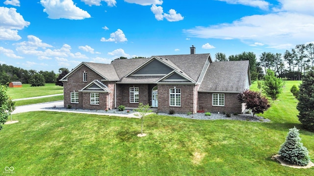 421 Lowry St, Jamestown, IN 46147 - view of front facade with a front yard, brick siding, and a chimney