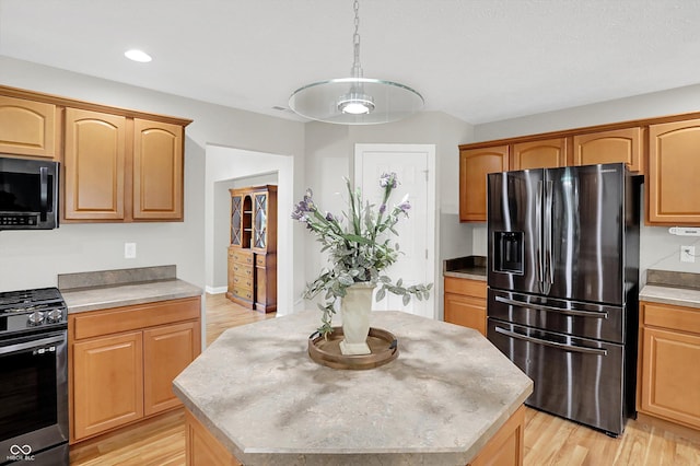 421 Lowry St, Jamestown, IN 46147 - kitchen featuring stainless steel appliances, a center island, light wood finished floors, light countertops, and recessed lighting