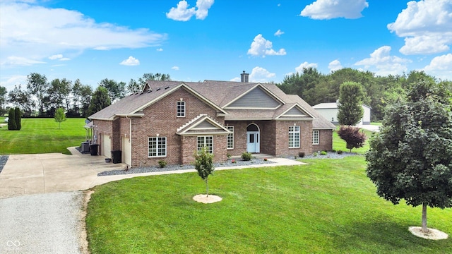 421 Lowry St, Jamestown, IN 46147 - view of front facade with brick siding, concrete driveway, a front lawn, and a shingled roof