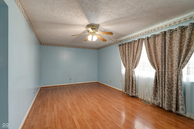 5425 Gambel Rd, Indianapolis, IN 46221 - spare room featuring ceiling fan, a textured ceiling, and wood finished floors