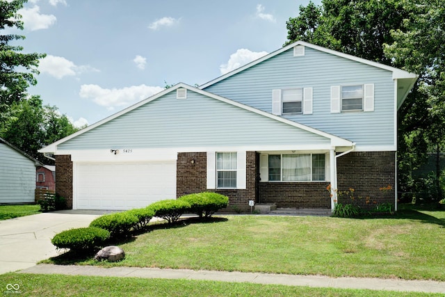 5425 Gambel Rd, Indianapolis, IN 46221 - view of front of property with brick siding, a garage, a front yard, and driveway