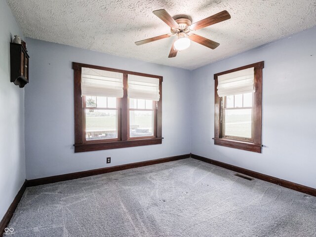 1556 E 400 S, Greenfield, IN 46140 - carpeted empty room with healthy amount of natural light, a textured ceiling, and a ceiling fan