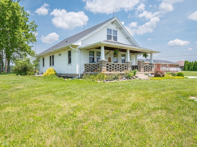 1556 E 400 S, Greenfield, IN 46140 - view of front of property with covered porch, a front yard, and a shingled roof