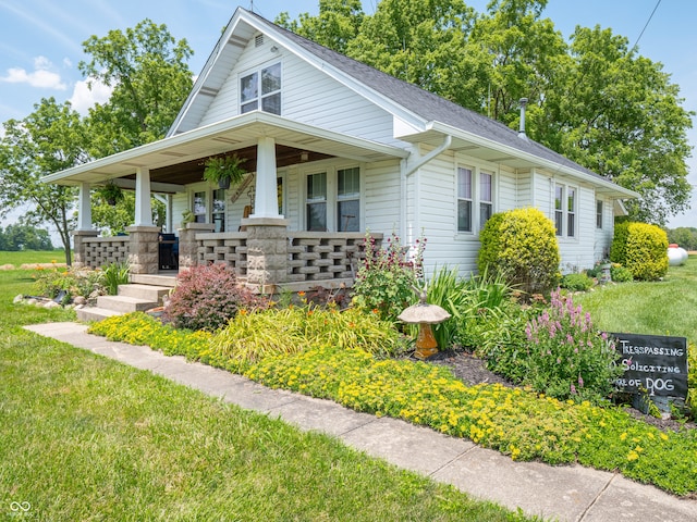1556 E 400 S, Greenfield, IN 46140 - bungalow-style home featuring covered porch, a front lawn, and a shingled roof