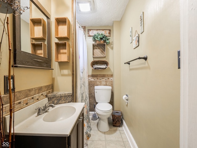 1556 E 400 S, Greenfield, IN 46140 - full bath with a textured ceiling, tile patterned floors, tile walls, vanity, and a wainscoted wall