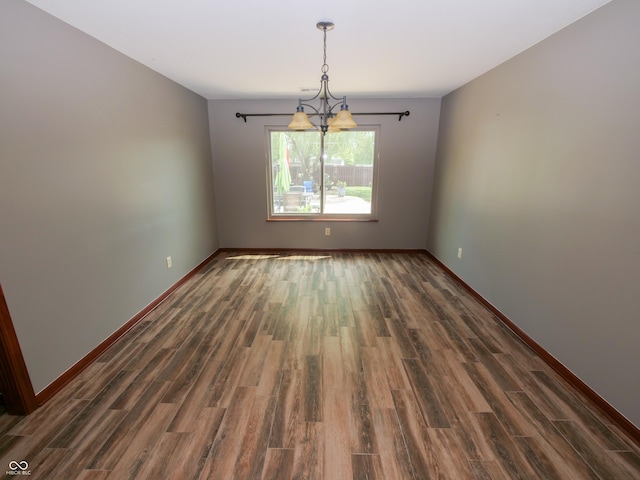 4443 W Windsong Ct, New Palestine, IN 46163 - unfurnished room featuring wood finished floors and a chandelier