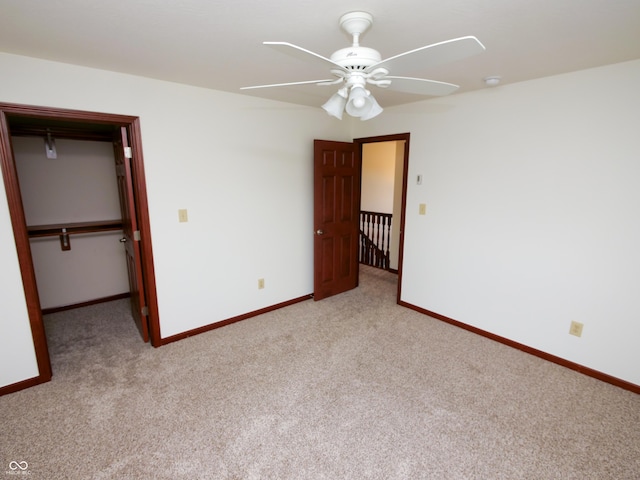 4443 W Windsong Ct, New Palestine, IN 46163 - unfurnished bedroom featuring carpet, a closet, a spacious closet, and a ceiling fan