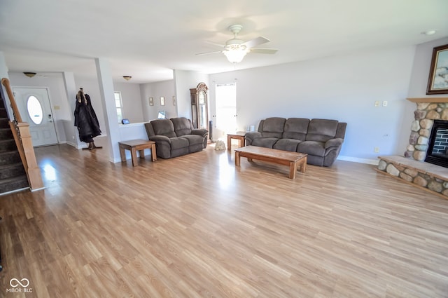 5652 Apple Branch Way, Indianapolis, IN 46237 - living area with ceiling fan, stairway, light wood-style flooring, and a fireplace