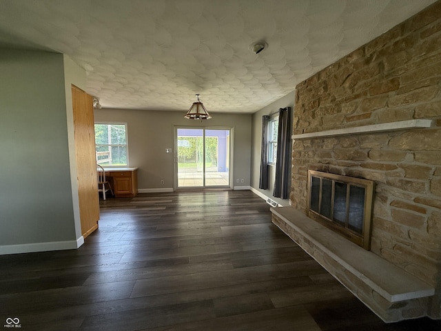 9808 E Troy Ave, Indianapolis, IN 46239 - unfurnished living room featuring a stone fireplace and dark wood-type flooring