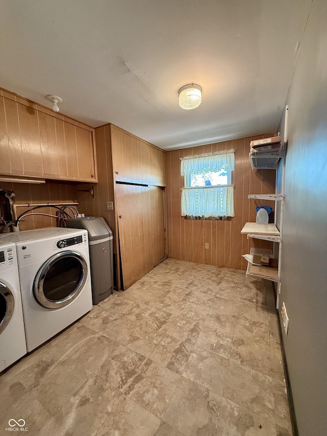 9808 E Troy Ave, Indianapolis, IN 46239 - laundry area featuring wooden walls, washer and dryer, and cabinet space