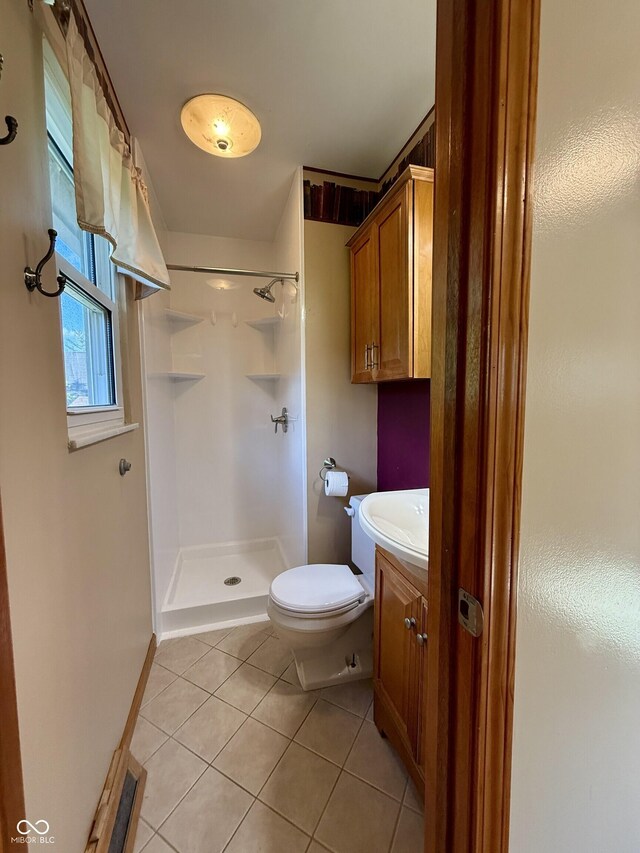 9808 E Troy Ave, Indianapolis, IN 46239 - bathroom featuring tile patterned flooring, a shower stall, and vanity