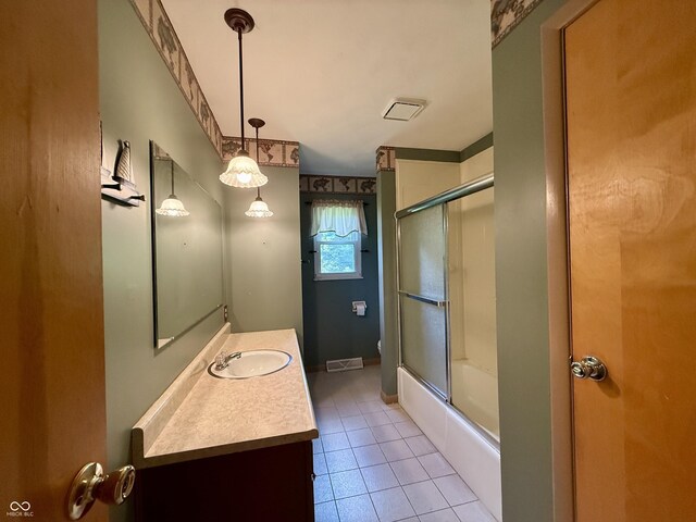 9808 E Troy Ave, Indianapolis, IN 46239 - full bath featuring vanity, shower / bath combination with glass door, and tile patterned flooring