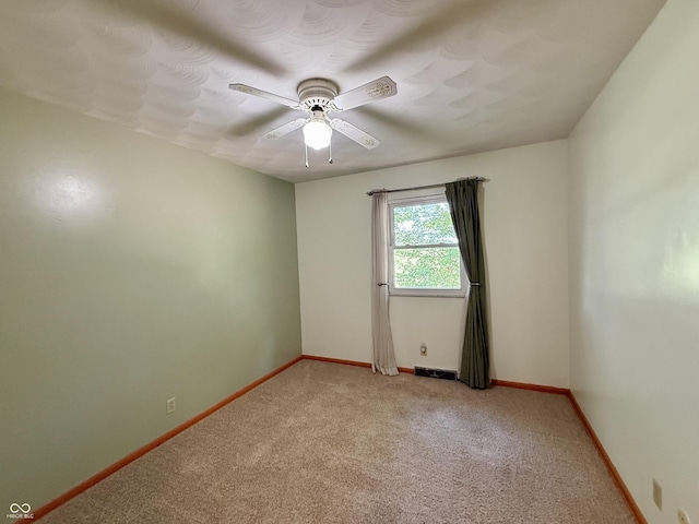 9808 E Troy Ave, Indianapolis, IN 46239 - spare room featuring light carpet and a ceiling fan