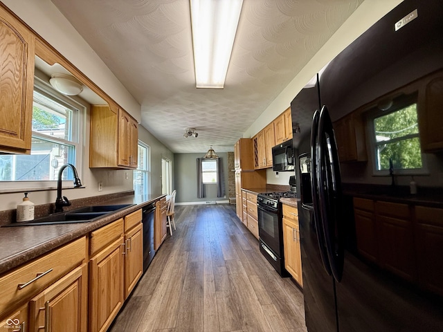 9808 E Troy Ave, Indianapolis, IN 46239 - kitchen with black appliances, dark wood-style flooring, dark countertops, and healthy amount of natural light