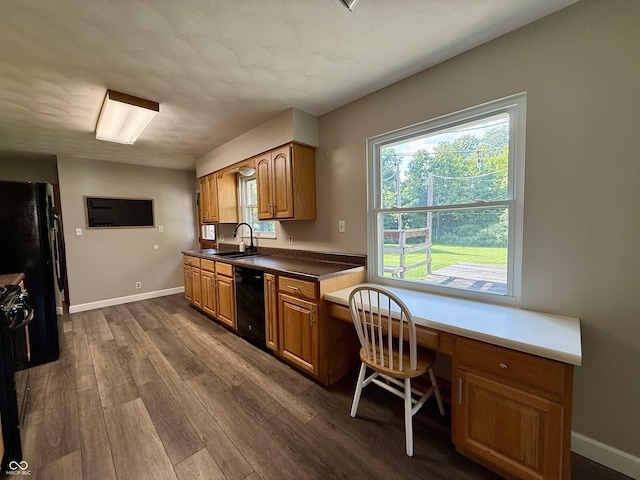 9808 E Troy Ave, Indianapolis, IN 46239 - kitchen featuring black appliances, dark wood-style floors, brown cabinets, and built in study area
