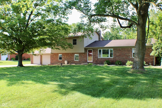 9808 E Troy Ave, Indianapolis, IN 46239 - split level home featuring brick siding, a front lawn, an attached garage, and roof with shingles