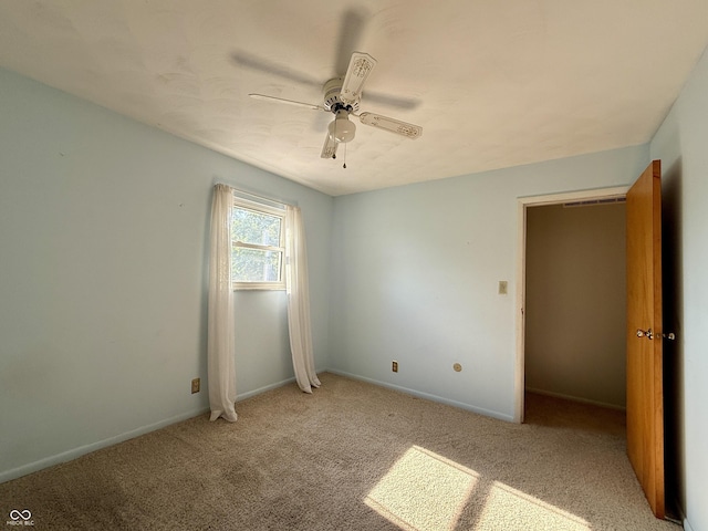 9808 E Troy Ave, Indianapolis, IN 46239 - unfurnished bedroom featuring light colored carpet and a ceiling fan