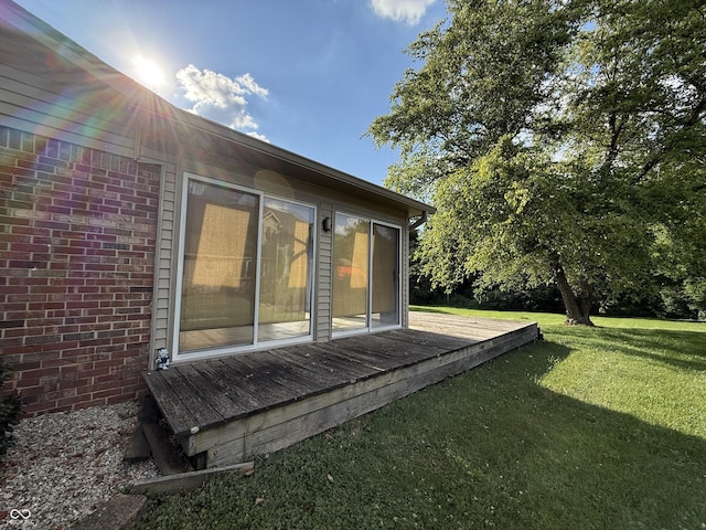 9808 E Troy Ave, Indianapolis, IN 46239 - view of side of home with brick siding, a yard, and a wooden deck