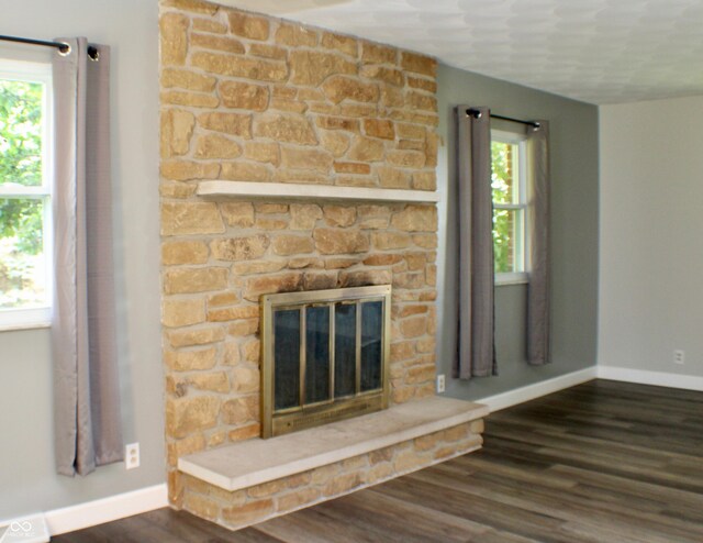 9808 E Troy Ave, Indianapolis, IN 46239 - unfurnished living room featuring dark wood-style floors and a fireplace