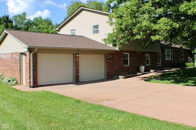9808 E Troy Ave, Indianapolis, IN 46239 - view of front of property with brick siding, an attached garage, concrete driveway, a front yard, and roof with shingles