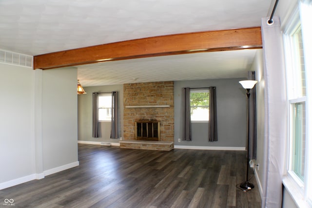 9808 E Troy Ave, Indianapolis, IN 46239 - unfurnished living room featuring dark wood-style flooring, a stone fireplace, and beamed ceiling