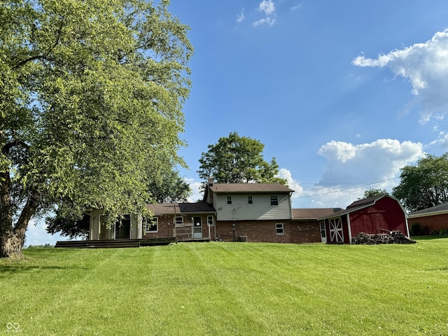 9808 E Troy Ave, Indianapolis, IN 46239 - back of house featuring brick siding, a yard, and an outdoor structure
